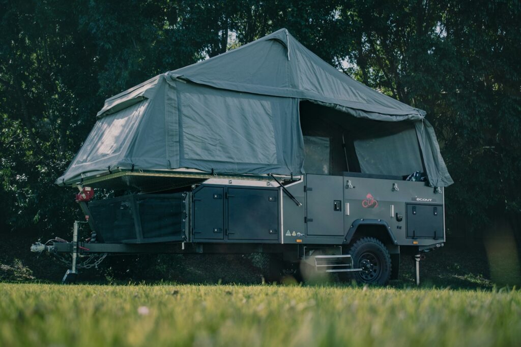 A tent is set up in the middle of a field