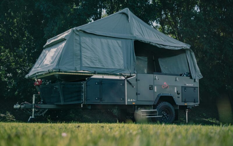 A tent is set up in the middle of a field